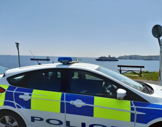 Police vehicle with view of seafront.